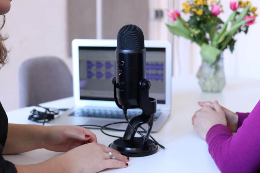 Two women recording a podcast