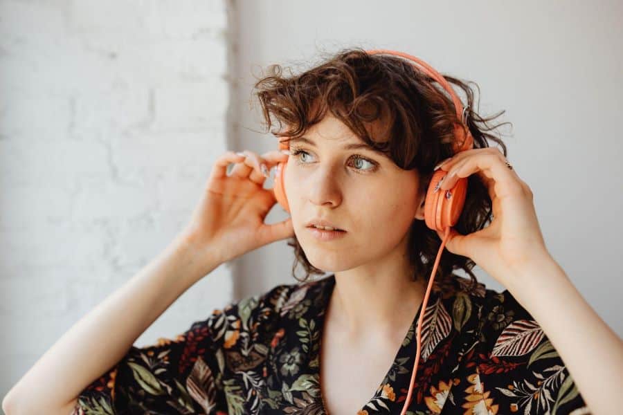 woman listening to podcast on headphones