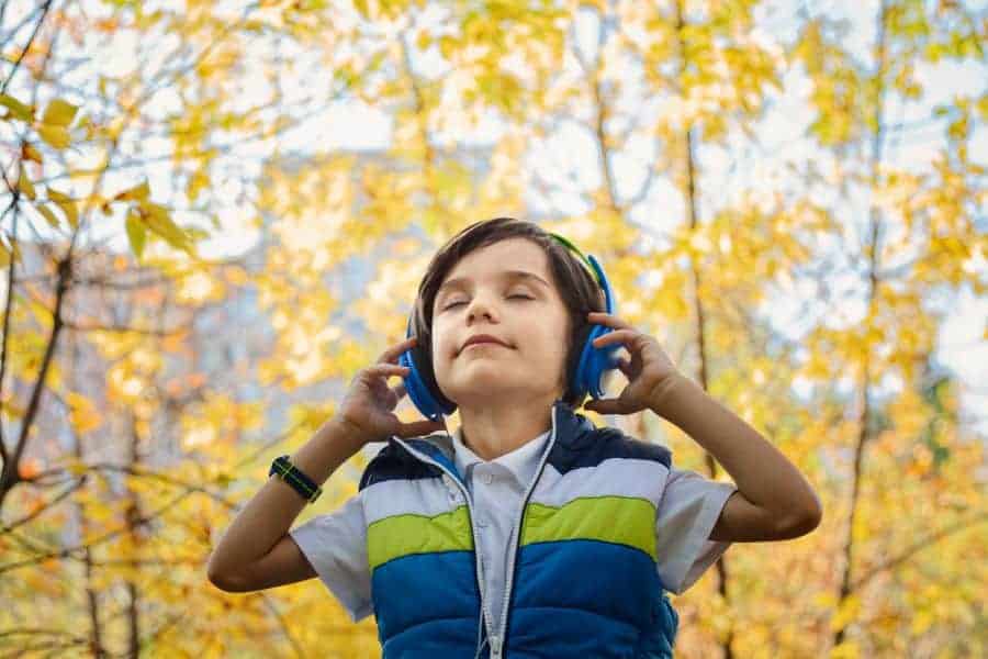 white child listening to podcast