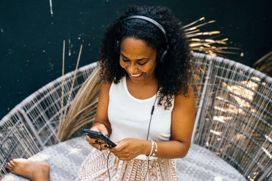 woman of color listens to podcast game