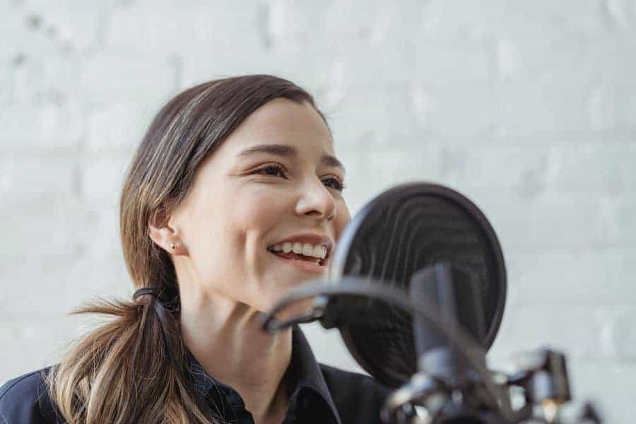woman podcasting pop filter