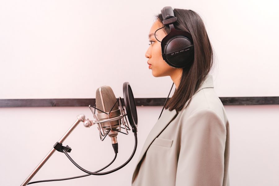 Woman Standing in Front of a Microphone