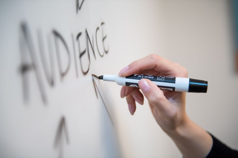 writing the word audience on a whiteboard with arrows