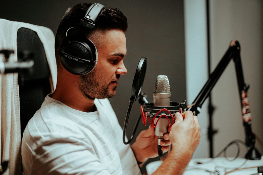 man using a professional podcasting microphone