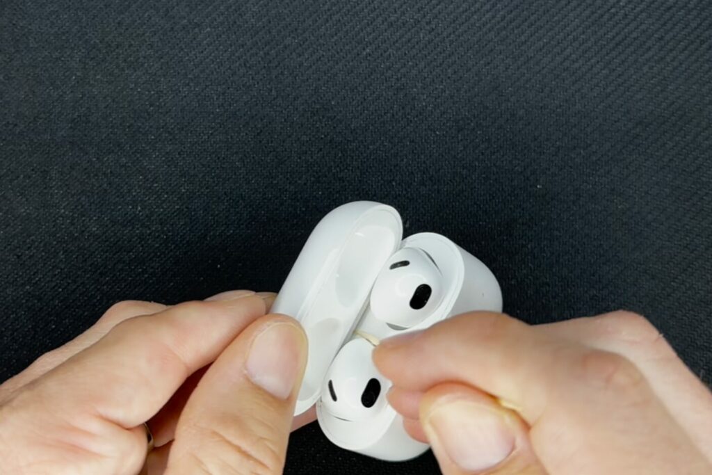 Clean airpod case hinges with toothpick to fix it not closing.