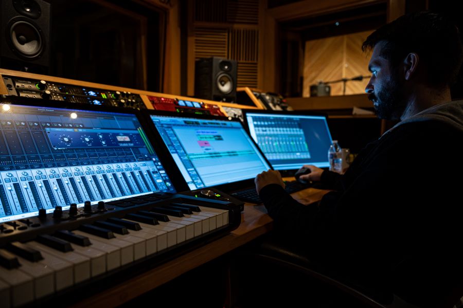 man recording audio with a piano