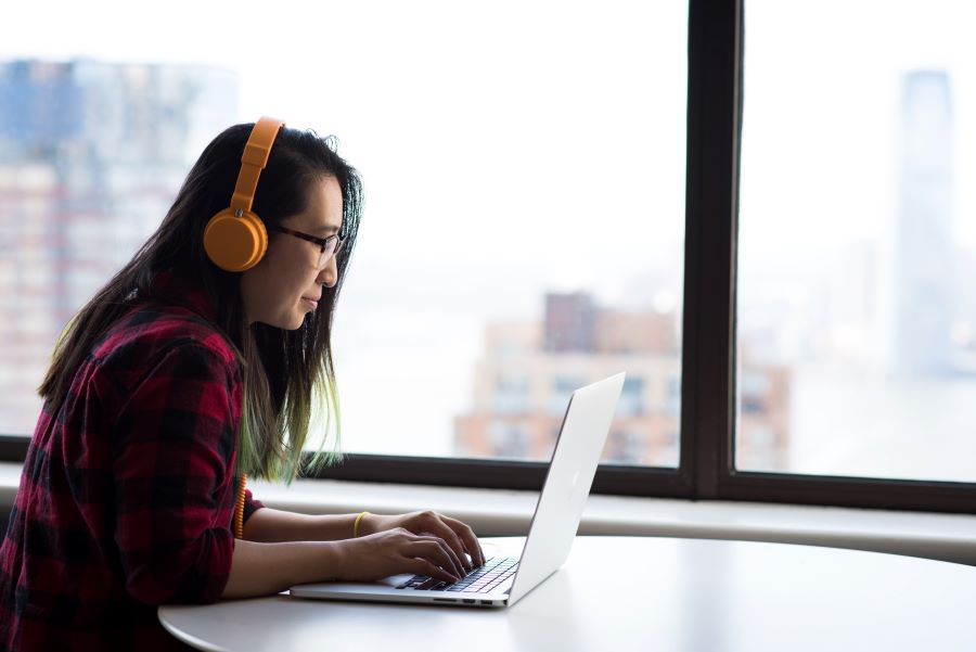 woman wearing orange headphones