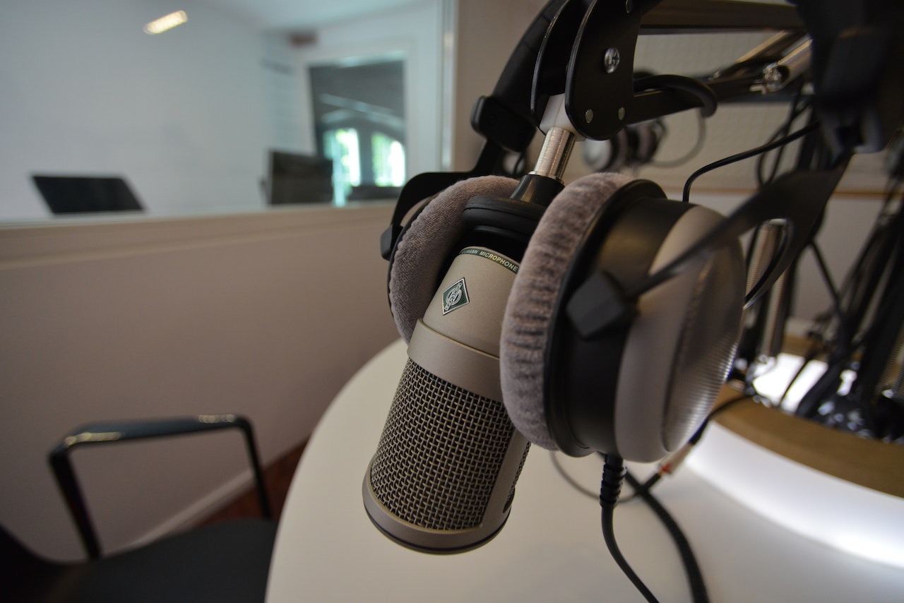 For microphone positioning in your podcast studio setup, ensure you adjust the angle and height in sync with your sitting or standing posture.
